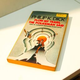 c1977 Philip K. Dick novel "Flow My Tears, the Policeman Said" Vintage Daw paperback